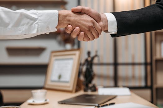 happy clients shaking hands with their lawyer