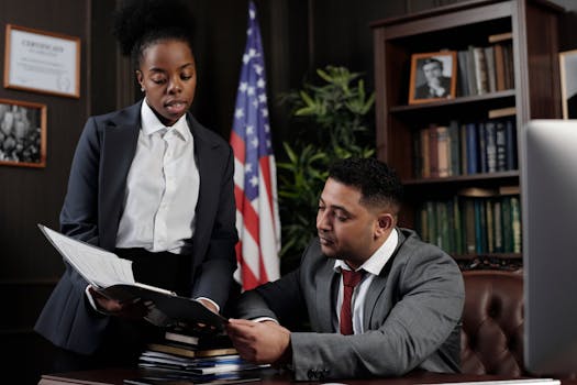 young lawyer at a desk with legal books